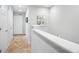 Upstairs hallway with neutral paint, plush carpet, white trim, and stylish art on the walls at 16019 E Elk Dr, Denver, CO 80239