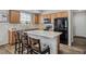 Bright kitchen features wood cabinetry, stainless appliances, and a functional center island at 16019 E Elk Dr, Denver, CO 80239