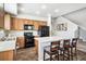 Bright kitchen features wooden cabinets, black appliances, and a center island with breakfast bar seating at 16019 E Elk Dr, Denver, CO 80239
