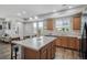 This kitchen features a large island, wood cabinets, and plenty of natural light from the multiple windows at 16019 E Elk Dr, Denver, CO 80239