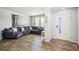 Cozy living room featuring a large sectional couch, wood floors, and natural light at 16019 E Elk Dr, Denver, CO 80239