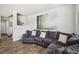 Inviting living room with a large sofa, natural wood flooring, and modern artwork at 16019 E Elk Dr, Denver, CO 80239