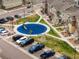 Aerial view of a community playground and parking area showcasing the residential landscape at 15345 W 64Th Ln # 107, Arvada, CO 80007