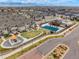 Aerial view of a community featuring a pool and playground, surrounded by well-maintained homes at 15345 W 64Th Ln # 107, Arvada, CO 80007