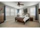 Bright bedroom with large windows, ceiling fan, and modern decor creates a peaceful ambiance at 15345 W 64Th Ln # 107, Arvada, CO 80007