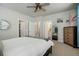 Spacious bedroom with carpet, ceiling fan, and ensuite bathroom, and closet for optimal storage at 15345 W 64Th Ln # 107, Arvada, CO 80007