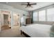 Comfortable bedroom with carpet floors, bright windows, and ensuite bathroom and storage at 15345 W 64Th Ln # 107, Arvada, CO 80007