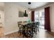 Dining area with modern lighting fixture and sliding glass doors to a private balcony at 15345 W 64Th Ln # 107, Arvada, CO 80007