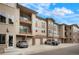View of condo building with garages and parking, showcasing its practical design at 15345 W 64Th Ln # 107, Arvada, CO 80007