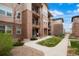 Well-maintained condo building with attractive landscaping, pathways, and private outdoor spaces at 15345 W 64Th Ln # 107, Arvada, CO 80007