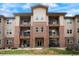Inviting three-story condo building featuring brick accents and private balconies for outdoor enjoyment at 15345 W 64Th Ln # 107, Arvada, CO 80007