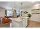Bright open-concept kitchen with granite countertops, stainless steel appliances, and a large island at 15345 W 64Th Ln # 107, Arvada, CO 80007