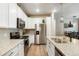 Bright kitchen with white cabinetry, stainless steel appliances, and ample counter space at 15345 W 64Th Ln # 107, Arvada, CO 80007