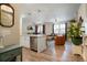 Open-concept living area featuring hardwood floors, modern lighting, and a comfortable seating arrangement at 15345 W 64Th Ln # 107, Arvada, CO 80007