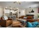 Spacious living room with stylish decor, leather seating, and an inviting atmosphere at 15345 W 64Th Ln # 107, Arvada, CO 80007
