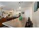 Open floorplan joining a living room with a large dining table, with a kitchen and front room in view at 15345 W 64Th Ln # 107, Arvada, CO 80007