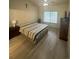 Bedroom featuring light wood floors, ceiling fan, and window for natural light at 12235 E 2Nd Dr, Aurora, CO 80011