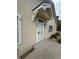 Charming front door with a white trim and screen door, complemented by beautiful landscaping at 12235 E 2Nd Dr, Aurora, CO 80011