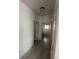 Hallway featuring wood-look flooring and doors to other rooms in the home at 12235 E 2Nd Dr, Aurora, CO 80011