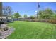 Spacious backyard with a well-manicured lawn, a covered patio, and a private fence line enhancing outdoor living at 1733 S Urban Way, Lakewood, CO 80228