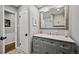 Well-lit bathroom features a granite countertop vanity, modern fixtures, large mirror, and decorative tile flooring at 1733 S Urban Way, Lakewood, CO 80228