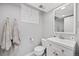 Bright bathroom featuring a modern vanity and mirror, complemented by neutral walls and stylish fixtures at 1733 S Urban Way, Lakewood, CO 80228
