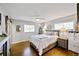 Relaxing bedroom featuring hardwood floors, a ceiling fan, and abundant natural light at 1733 S Urban Way, Lakewood, CO 80228