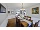 Dining room boasting hardwood floors, neutral paint and modern chandelier at 1733 S Urban Way, Lakewood, CO 80228