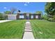 Inviting home showcasing a well-manicured lawn and a charming walkway to the front door at 1733 S Urban Way, Lakewood, CO 80228