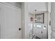 Inviting foyer with a modern chandelier and white door, leading to a bright and welcoming home at 1733 S Urban Way, Lakewood, CO 80228