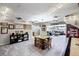 Open concept game room with a vintage-themed ceiling, shuffleboard table, and views into the adjacent living area at 1733 S Urban Way, Lakewood, CO 80228