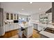Bright, modern kitchen with island, stainless steel appliances, and hardwood floors at 1733 S Urban Way, Lakewood, CO 80228