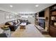 Comfortable living room with a brick fireplace, custom bookshelves, and a large leather sofa for cozy evenings at 1733 S Urban Way, Lakewood, CO 80228