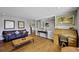 Spacious living room featuring hardwood floors and neutral paint scheme, bathed in natural light at 1733 S Urban Way, Lakewood, CO 80228