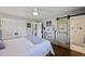 Cozy primary bedroom with barn door to ensuite, hardwood floors and neutral paint at 1733 S Urban Way, Lakewood, CO 80228