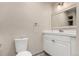 Well-lit bathroom featuring a toilet and vanity with modern finishes at 3049 E Long S Cir, Centennial, CO 80122