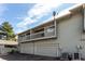 Townhome exterior showing garages and a balcony with a satellite dish at 3049 E Long S Cir, Centennial, CO 80122