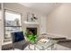 Inviting room featuring a fireplace and view of greenery seen from a large window at 3049 E Long S Cir, Centennial, CO 80122
