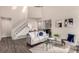 Bright living room features a staircase and a stylish seating arrangement at 3049 E Long S Cir, Centennial, CO 80122