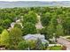 View of the house from the sky shows neighborhood with many trees and mountain range in the distance at 823 Timothy Dr, Longmont, CO 80503