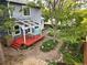Aerial view of backyard with patio, white pergola and mature trees and landscaping at 823 Timothy Dr, Longmont, CO 80503