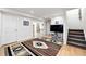 Finished basement with hardwood flooring, a decorative rug, and staircase leading to the upper level at 823 Timothy Dr, Longmont, CO 80503
