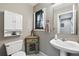Cozy bathroom featuring a pedestal sink, storage cabinet, and decorative accents at 823 Timothy Dr, Longmont, CO 80503