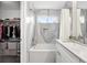 Bright bathroom features tub with shower, marble vanity and walk-in closet at 823 Timothy Dr, Longmont, CO 80503