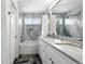 Bathroom featuring a double sink, white cabinets, a tub with shower, and modern finishes at 823 Timothy Dr, Longmont, CO 80503