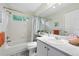 Clean bathroom features a shower-tub, vanity, and view to outdoors at 823 Timothy Dr, Longmont, CO 80503