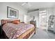 Cozy bedroom features neutral carpet, a ceiling fan and attached bathroom at 823 Timothy Dr, Longmont, CO 80503