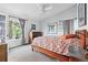 Bright bedroom features a ceiling fan, and natural light from a large picture window at 823 Timothy Dr, Longmont, CO 80503