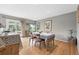 Bright dining room features wood floors, a window with greenery and sliding glass doors to an outdoor deck at 823 Timothy Dr, Longmont, CO 80503