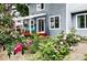 Exterior shot of house and backyard with blooming rose bushes at 823 Timothy Dr, Longmont, CO 80503